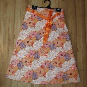Knee-length floral trapeze skirt.